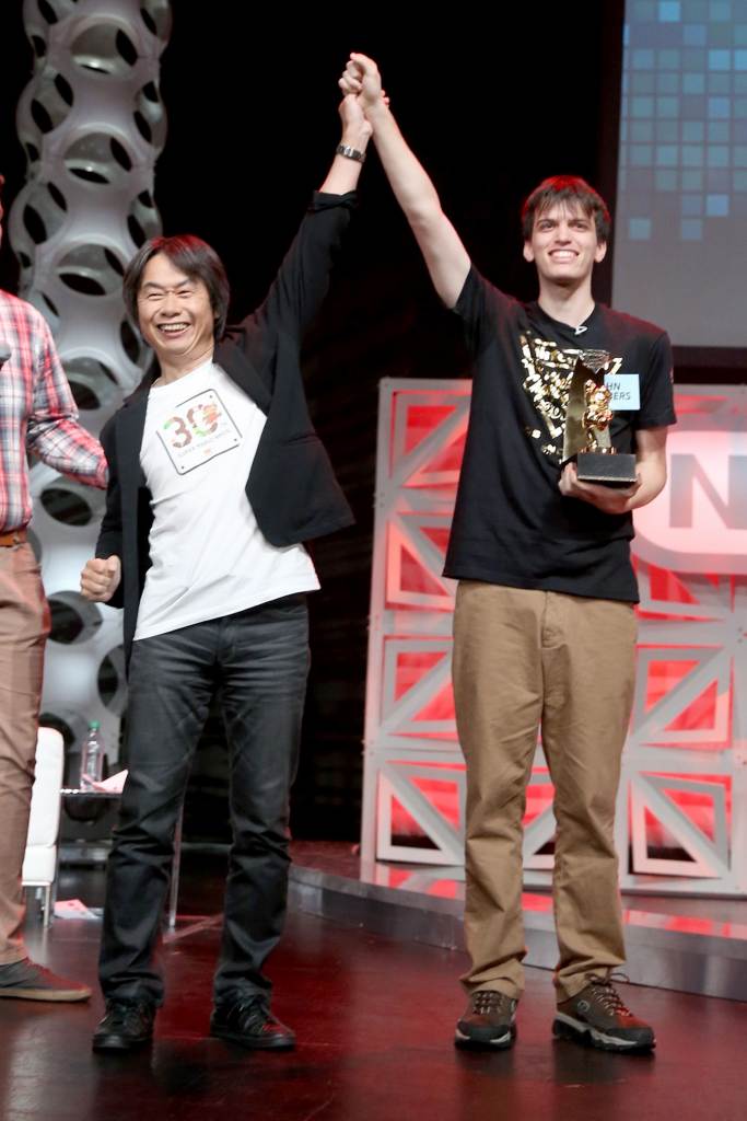 LOS ANGELES, CA - JUNE 14:  In this photo provided by Nintendo of America, 2015 Nintendo World Champion John Goldberg (R) of Queens, New York, receives the grand-prize trophy from video game developer Shigeru Miyamoto, creator of the Super Mario Bros., The Legend of Zelda and Donkey Kong series, among others. Fans in the audience and watching online celebrated the return of the event after a 25-year hiatus and cheered on 16 contestants as they competed across a variety of Nintendo video games.  (Photo by Jonathan Leibson/Getty Images for Nintendo of America)