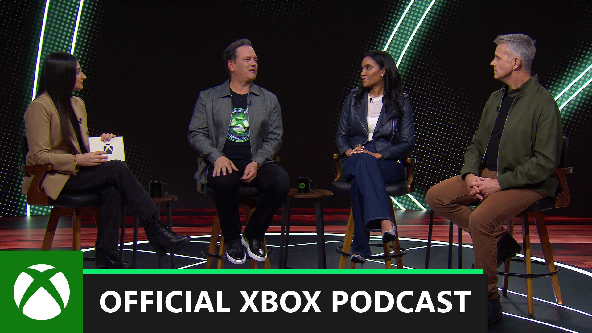 tina amini, phil spencer, sarah bond, and matt booty on podcast set. labeled official xbox podcast